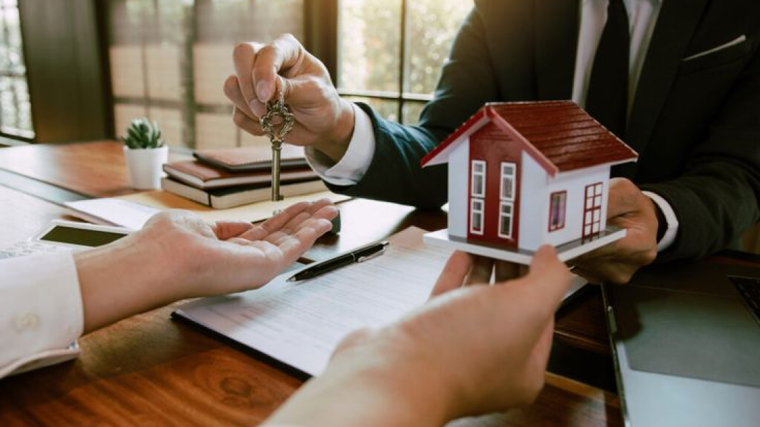 Home agents are handing out keys to home buyers who are signing contracts at the office.